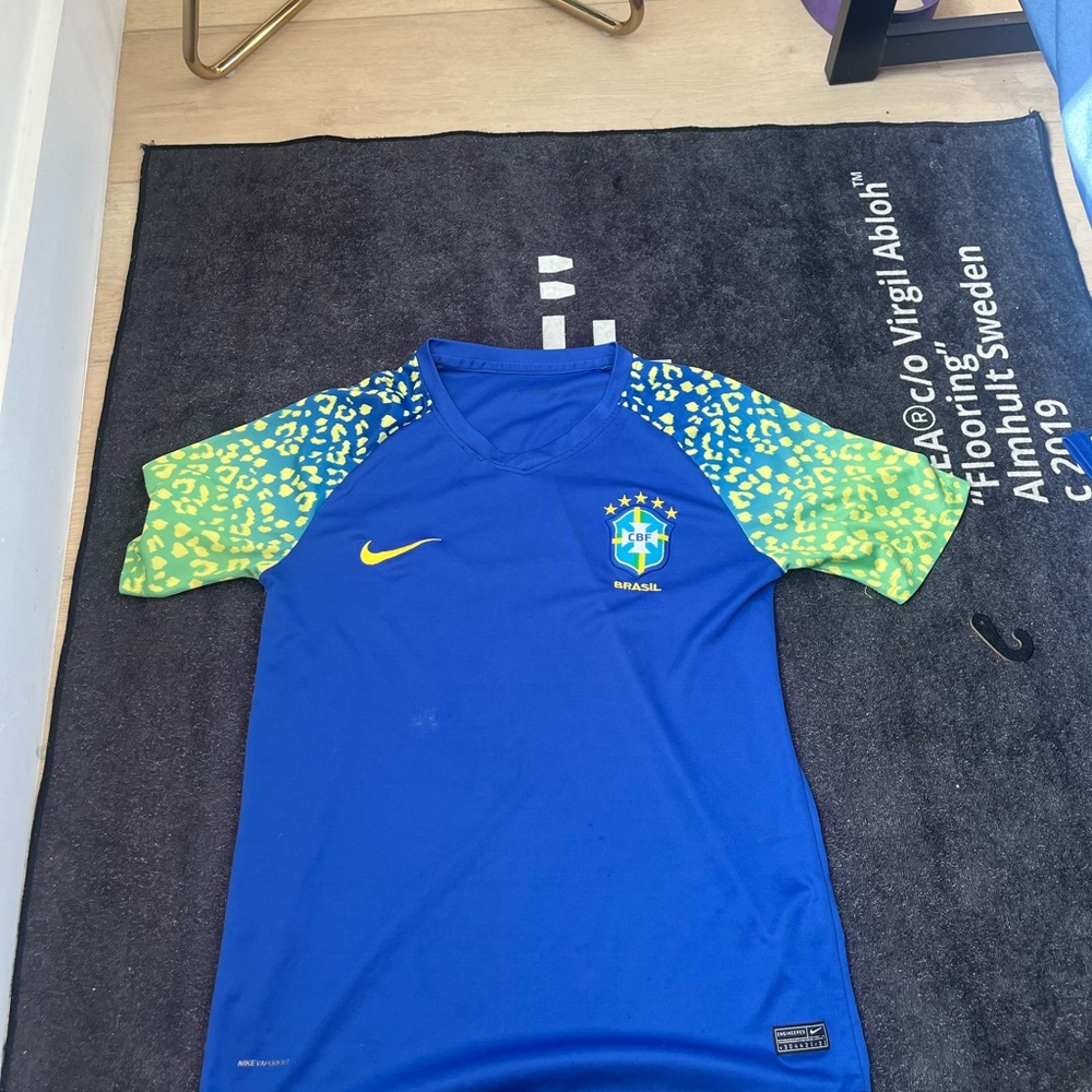 nike the shirt, size small in mens and the color is blue with a greenish yellow
